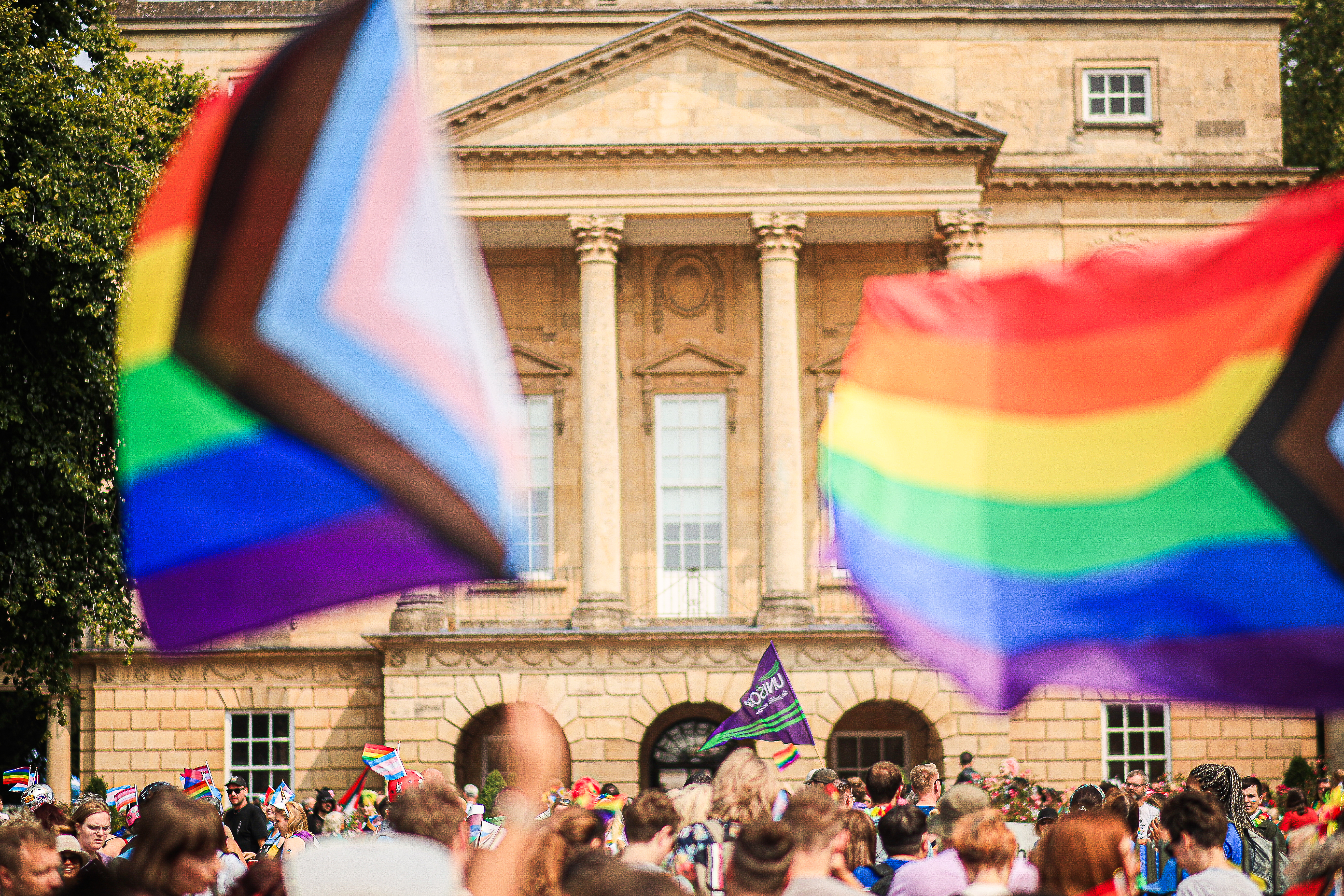 The crowd outside the Holburne museum with various pride flags