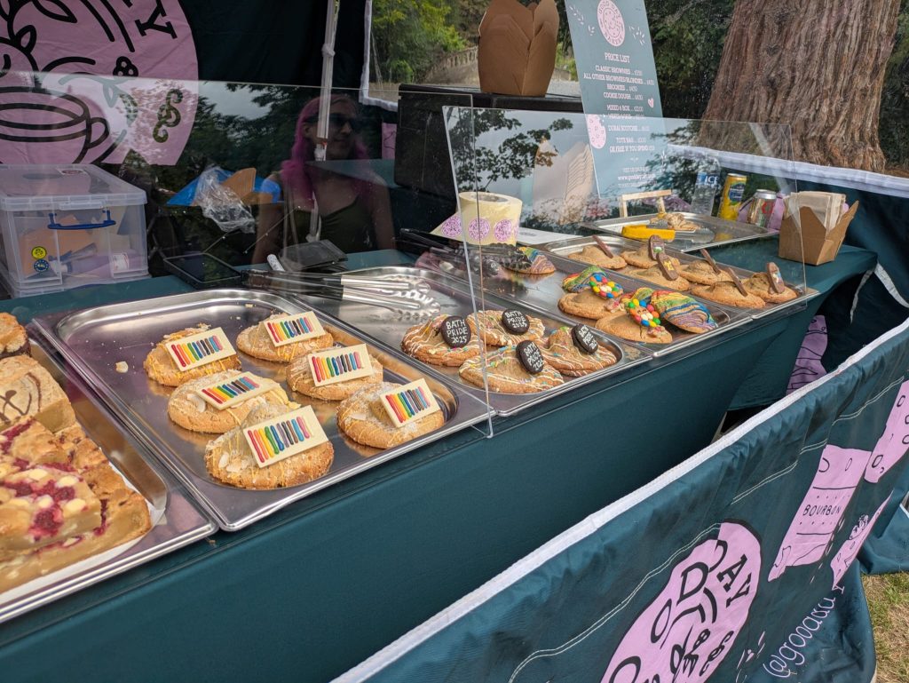 an assortment of cookies at a food stall decorated for Pride